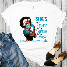 Load image into Gallery viewer, African American Black Woman Nurse wearing a face mask, nurses hat with a red cross, blue rubber glove on her right hand, making a fist with a stethoscope in her fist. The word nurse is tattooed on her arm with the fist. There is blue hearts and the words She's Black Queen Nurse Living Her Best Life. Black shoes and blue jeans is also in the picture.