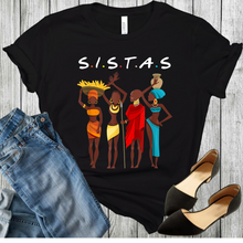 Load image into Gallery viewer, Black History SISTAS African American Girls Black Pride. 4 African dressed Women on a black t-shirt with black shoes and blue jeans in a the picture.