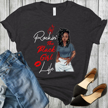 Load image into Gallery viewer, Young African American Black Woman on a black t-shirt with locs/dreds wearing a crop top and white pants. With the words Rockin the black girl life. Black shoes and blue jeans in the picture.