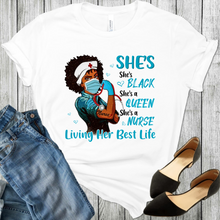 Load image into Gallery viewer, African American Black Woman Nurse wearing a face mask, nurses hat with a red cross, blue rubber glove on her right hand, making a fist with a stethoscope in her fist. The word nurse is tattooed on her arm with the fist. There is blue hearts and the words She&#39;s Black Queen Nurse Living Her Best Life. Black shoes and blue jeans is also in the picture.
