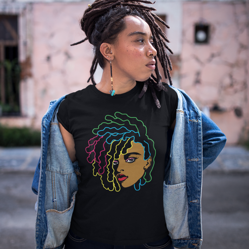 African American black woman wearing a black t-shirt with a black woman's head and face with colorful outlined locs/ dreds. She has dreds/locs herself and is wearing blue jeans.