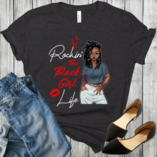 Load image into Gallery viewer, Young African American Black Woman on a black t-shirt with locs/dreds wearing a crop top and white pants. With the words Rockin the black girl life. Black shoes and blue jeans in the picture.
