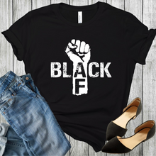 Load image into Gallery viewer, Black t-shirt with a fist and the word black in white color and AF in black color on the arm of the fist. Black shoes and blue jeans are in the bottom corners.
